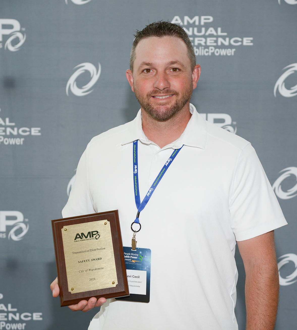 A recipient of the AMP Safety Award holding his plaque.