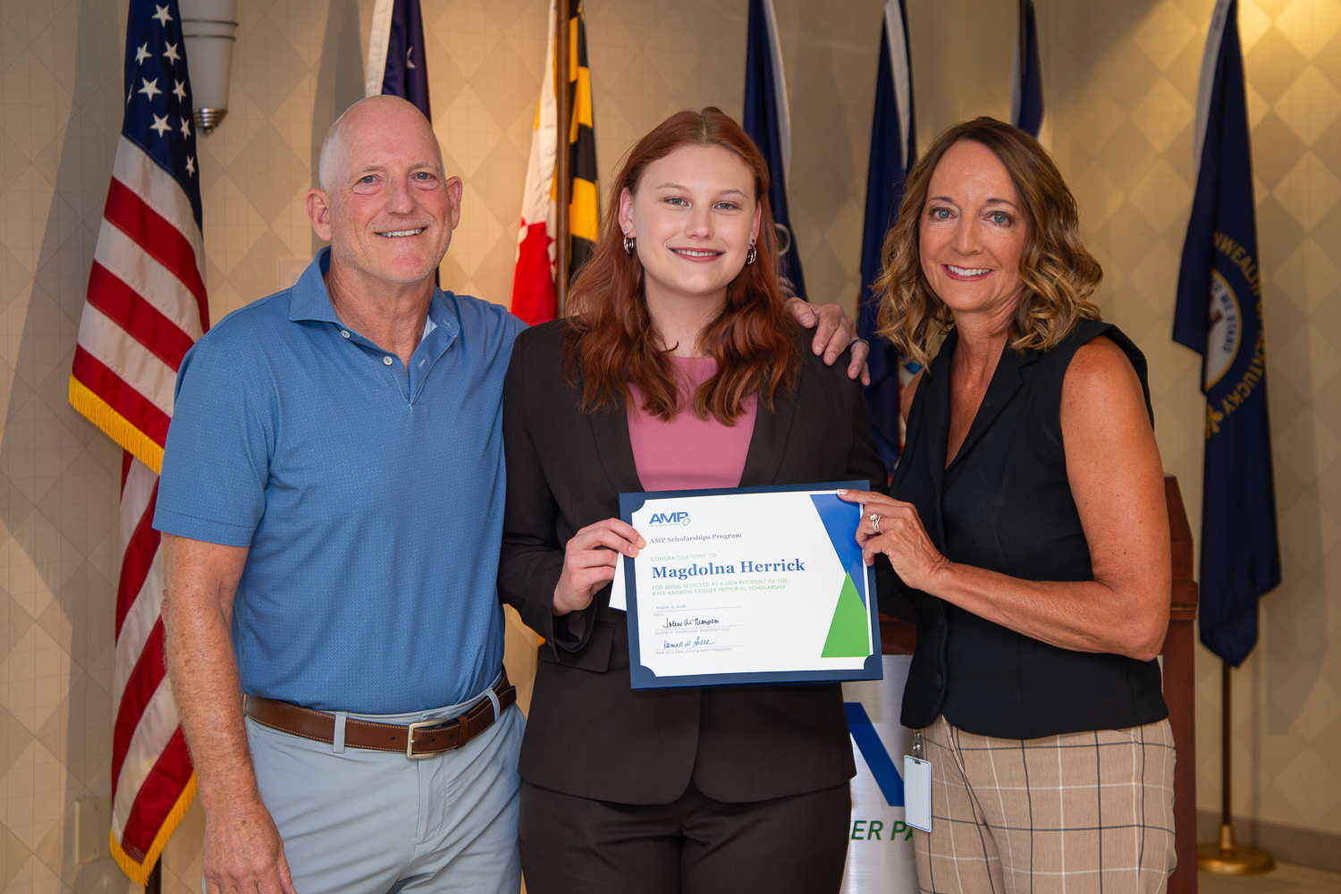 Herrick (center) was presented with the scholarship by Kyle Krieger’s father, Ed Krieger (left), who is the Deputy City Manager — Infrastructure and Public Utilities for the City of Westerville, and is the former Director of the Piqua Power System and a former member of the AMP Board of Trustees; and his stepmother, Pam Sullivan, AMP Chief Operating Officer and President of AMP Transmission